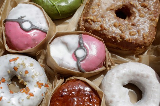 Pecha Berry Pokeseed doughnuts, top left and center, are displayed in a box of doughnuts from Doughnut Plant, in New York. (AP Photo/Mark Lennihan)