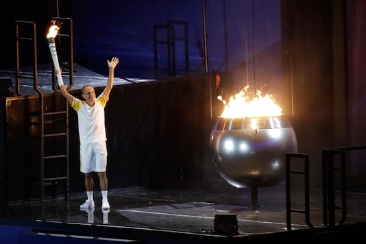 Brazilian marathoner Vanderlei de Lima lights the Olympic flame during the opening ceremony at the Maracana Stadium. (AP)