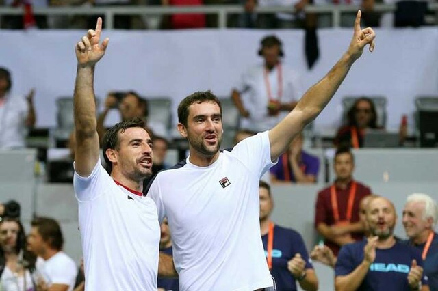 Croatia's Marin Cilic and Ivan Dodig react after winning their men's doubles match against France's Pierre-Hugues Herbert and Nicolas Mahut.  (Photo Credit: Reuters)
