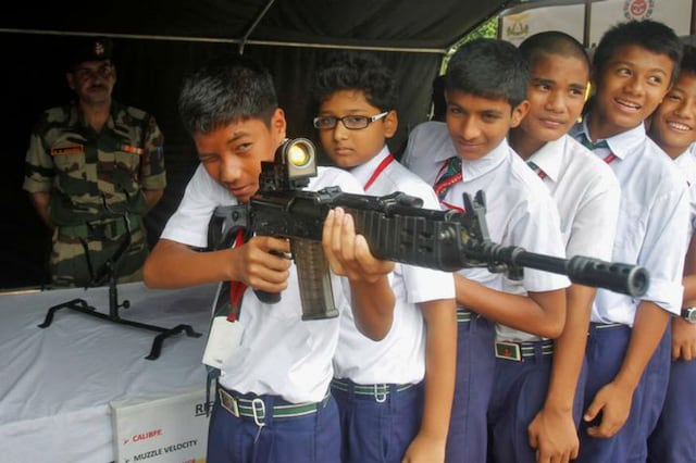 


A school boy holds an INSAS (Indian Small Arms System) assault rifle on display during a programme organized by Assam Rifles, a paramilitary force, to attract youth in joining the force at their headquarters in Agartala, India, October 27, 2016. REUTERS/Jayanta Dey