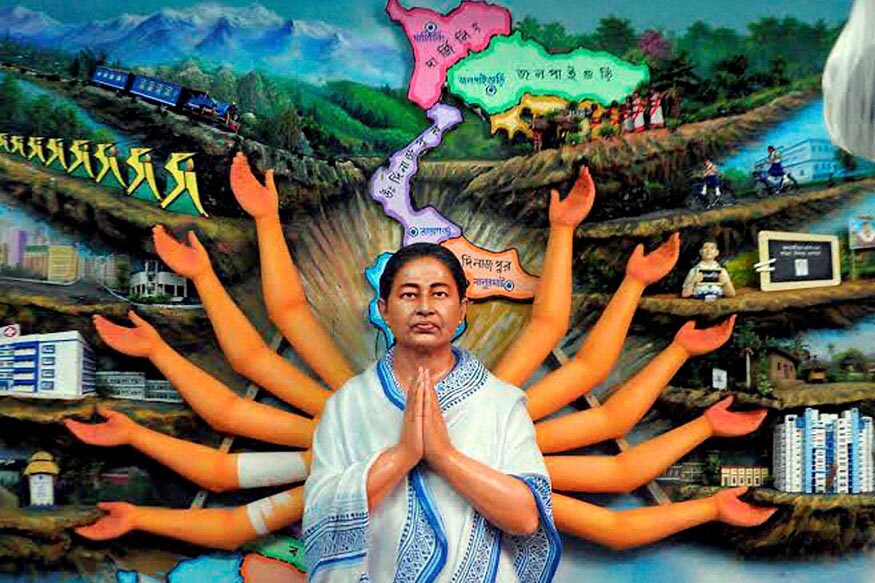 A man walks past a graffiti of Chief Minister of West Bengal state Mamata  Banerjee with a trident ahead of the upcoming assembly elections in  Kolkata, India, Saturday, March 6, 2021. The