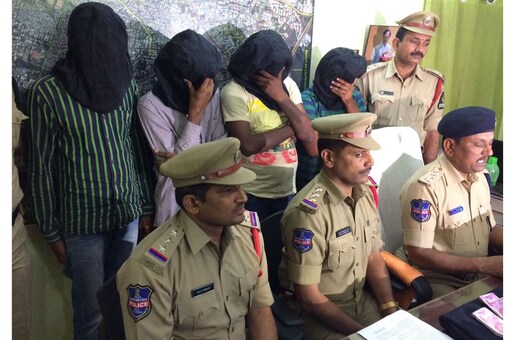 Police holding a press conference with the accused 