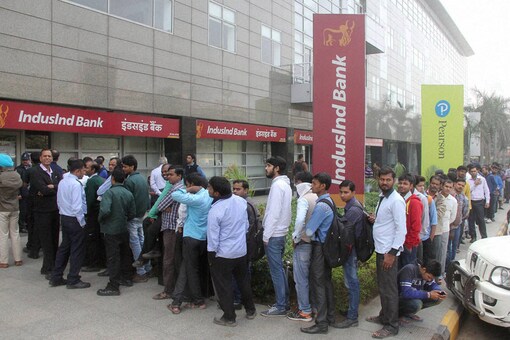 People queue up outside a bank to withdraw cash  (PTI Photo)