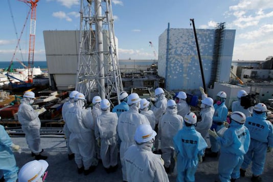 File photo of members of the media, wearing protective suits and masks, receiving briefing from Tokyo Electric Power Co employees (in blue). (Reuters Photo) File photo of members of the media, wearing protective suits and masks, receiving briefing from Tokyo Electric Power Co employees (in blue). (Reuters Photo)
