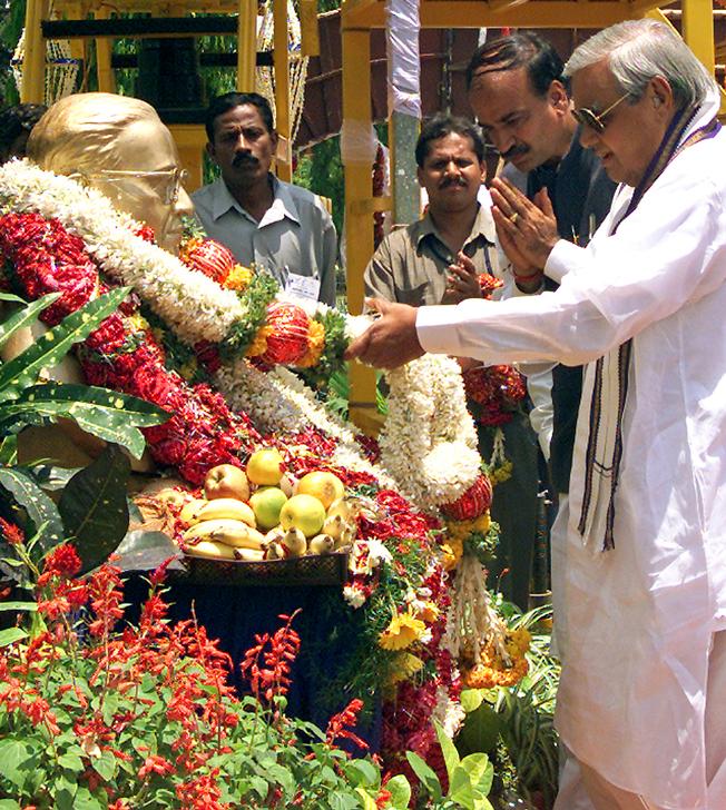 Then PM Atal Bihari Vajpayee places a garland on a statue of BR Ambedkar in Bangalore on April 14, 2004. (Reuters) 