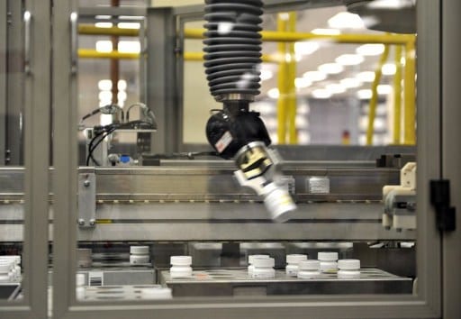 An automated robot arm picks up a bottle of prescription pills December 2, 2010 in the Medco pharmacy plant in Willingboro, New Jersey. Medcos state-of-the-art automated pharmacy, the largest in the world, can dispense up to one million prescriptions a week. The plant prepares up to 10,000 packages a day that are mailed to customers who get their prescriptions through Medco. AFP PHOTO/Stan HONDA / AFP PHOTO / STAN HONDA