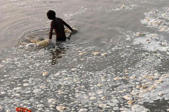 A devotee takes a holy dip in the polluted Sangam, confluence of three rivers, the Ganga, the Yamuna and mythical Saraswati, in Allahabad. (File Photo/PTI)