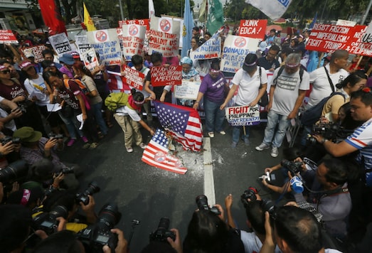 Protesters burn a mock U.S. flag and a real one during a rally at the U.S. Embassy to coincide with the inauguration of President-elect Donald Trump as the 45th President of the United States Friday (AP) Protesters burn a mock U.S. flag and a real one during a rally at the U.S. Embassy to coincide with the inauguration of President-elect Donald Trump as the 45th President of the United States Friday (AP)