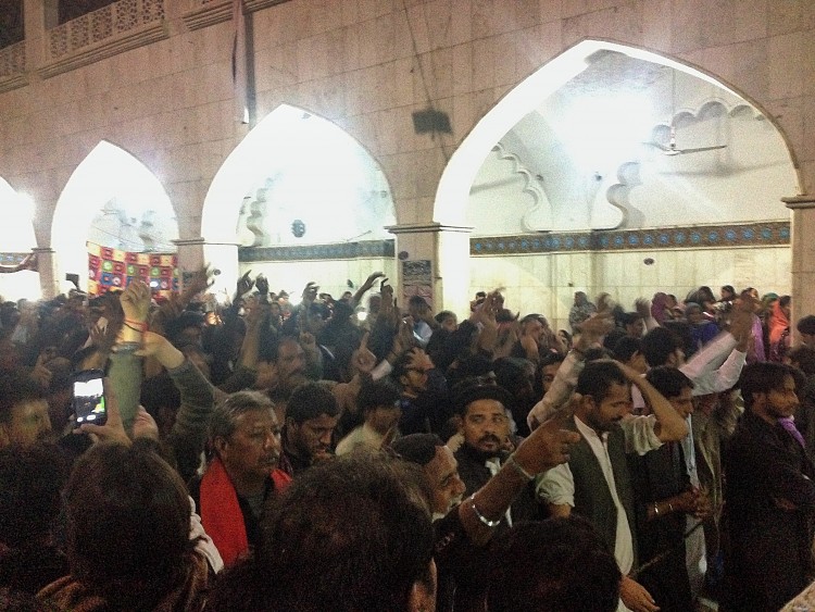 Worshippers during dhamaal reaching out for the sky, asking for Shahbaz Qalandar’s blessings and chanting Hazrat Ali’s name in remembrance.