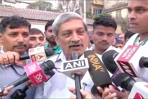 Defence Minister Manohar Parrikar talks to reporters after voting in Goa.