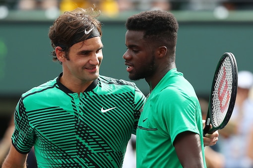 Roger Federer and Frances Tiafoe. (Getty Images)