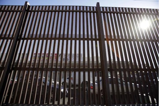 The Mexican border town of Mexicali is seen through the US-Mexico international border fence in Calexico. (Image: Reuters)