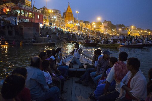 Devotees travel past holy ghats on the banks of the Ganga in Varanasi. (Representative image courtesy Reuters)