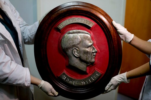 Members of the federal police show a bust relief portrait of Nazi leader Adolf Hitler at the Interpol headquarters in Buenos Aires, Argentina. (Photo: AP)