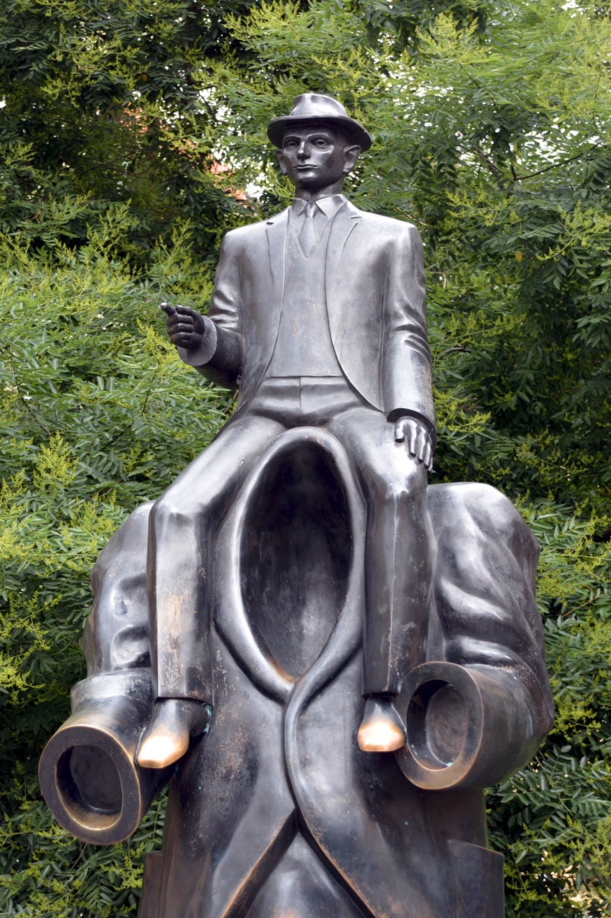 The tall black sculpture represents a headless male figure in a suit with a figure of Franz Kafka sitting on his shoulders. The sculptor, Jaroslav Rona says he found inspiration for the statue in Kafka's work. (Image: Getty Images)