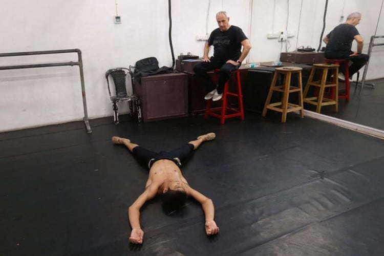 Amiruddin Shah, 16, speaks to his instructor Yehuda Maor during a practice session at a dance academy in Mumbai