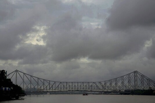 Kolkata: Sky covered with dark clouds at Ganga river near Howrah bridge in Kolkata on Wednesday. (Image: PTI)
