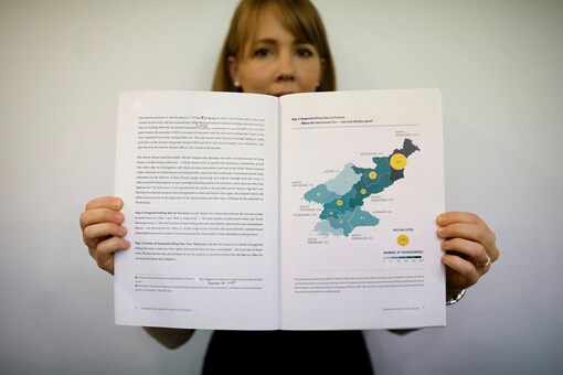 Sarah Son, research director of Transitional Justice Working Group, poses for photographs with a graphic showing suspected killing sites in North Korea in a report compiled by the group during an interview in Seoul, South Korea. (Photo: Reuters)