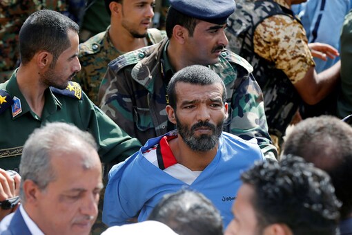 Police officers escort Muhammad al-Maghrabi, 41, who was convicted of raping and murdering a three-year-old girl, to the execution site, in Sanaa, Yemen (REUTERS)