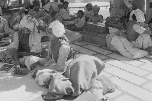 Refugees with their remaining belongings at the Golden Temple (Sri Harmandir Sahib), the holiest shrine of Sikhism, in Amritsar, Punjab, after communal riots during the Partition  (GETTY IMAGES)