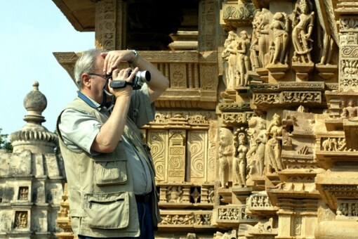 (A tourists clicks images at Khajuraho)