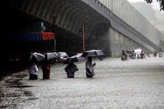 People wade along a flooded street during heavy rain in Mumbai. (Getty Images) People wade along a flooded street during heavy rain in Mumbai. (Getty Images)