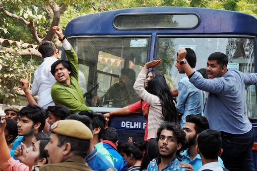 Police detaining ABVP activists after their clash with AISA students at Delhi University in Delhi. On February 21, members of RSS' student wing ABVP had gathered outside the college and shouted slogans in protest against the seminar for which JNU students Umar Khalid and Shehla Rashid were invited. (File Photo/PTI)