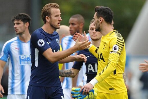 Harry Kane celebrate with Hugo Lloris following their win over Huddersfield. (Reuters)