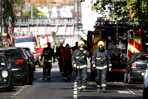 Fire brigade officers walk within a cordon near where an incident happened, that police say they are investigating as a terrorist attack, at Parsons Green subway station in London. (AP)