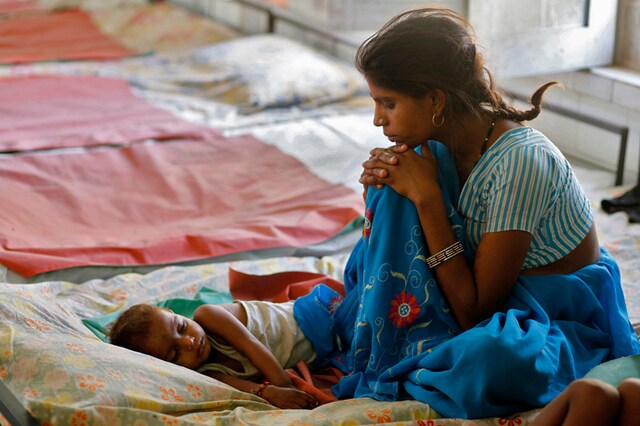 A mother looks at her malnourished child in the Nutritional Rehabilitation Centre of Sheopur district of Madhya Pradesh. (Reuters)