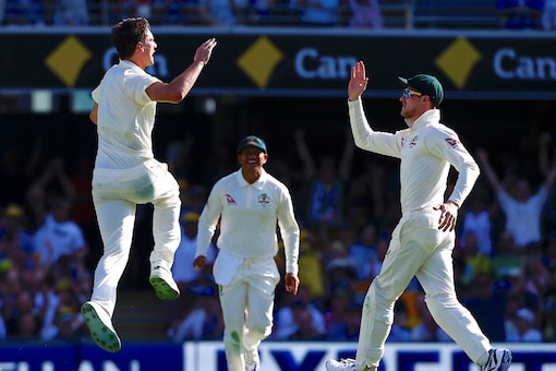 Australia's bowler Pat Cummins celebrates the wicket of England's batsman Joe Root on the first day of the first Ashes Test . (Reuters Image)