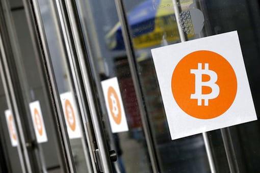 File photo, Bitcoin logos are displayed at the Inside Bitcoins conference and trade show in New York. (Photo: AP)