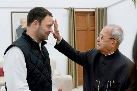 Congress Vice President Rahul being greeted by former president Pranab Mukherjee before he filed his nomination papers for party president's post, in New Delhi. (Image: PTI) Congress Vice President Rahul being greeted by former president Pranab Mukherjee before he filed his nomination papers for party president's post, in New Delhi. (Image: PTI)