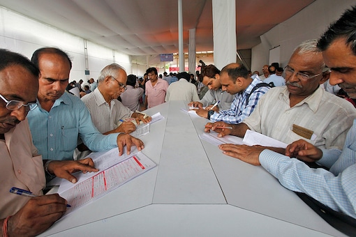 Tax payers fill up forms before submitting their income tax returns. (Reuters)