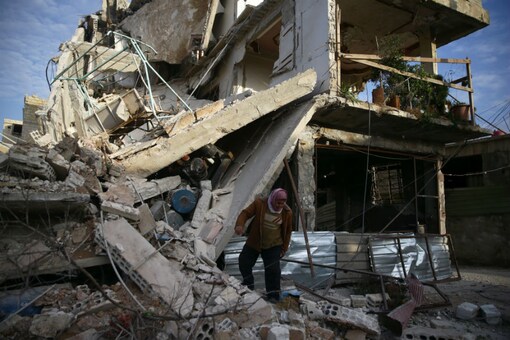 A person inspects damaged building in the besieged town of Douma, Eastern Ghouta, Damascus, Syria February 20, 2018. REUTERS/Bassam Khabieh