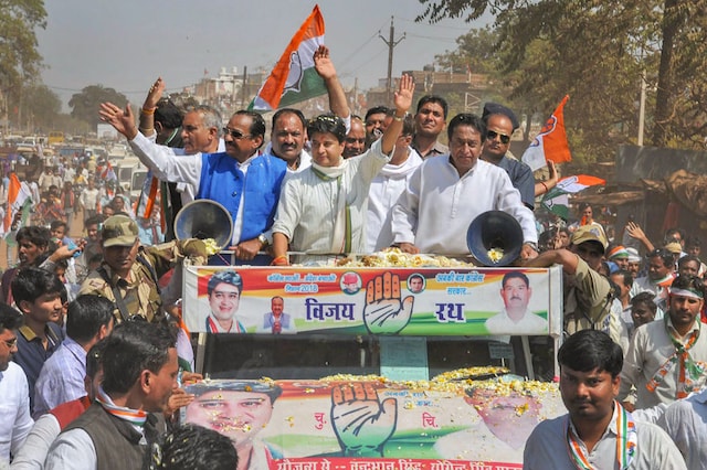 Congress leader Jyotiraditya Scindia with Kamal Nath and tribal leader Kantilal Bhuria take part in a road show before a public meeting in Madhya Pradesh. (PTI)