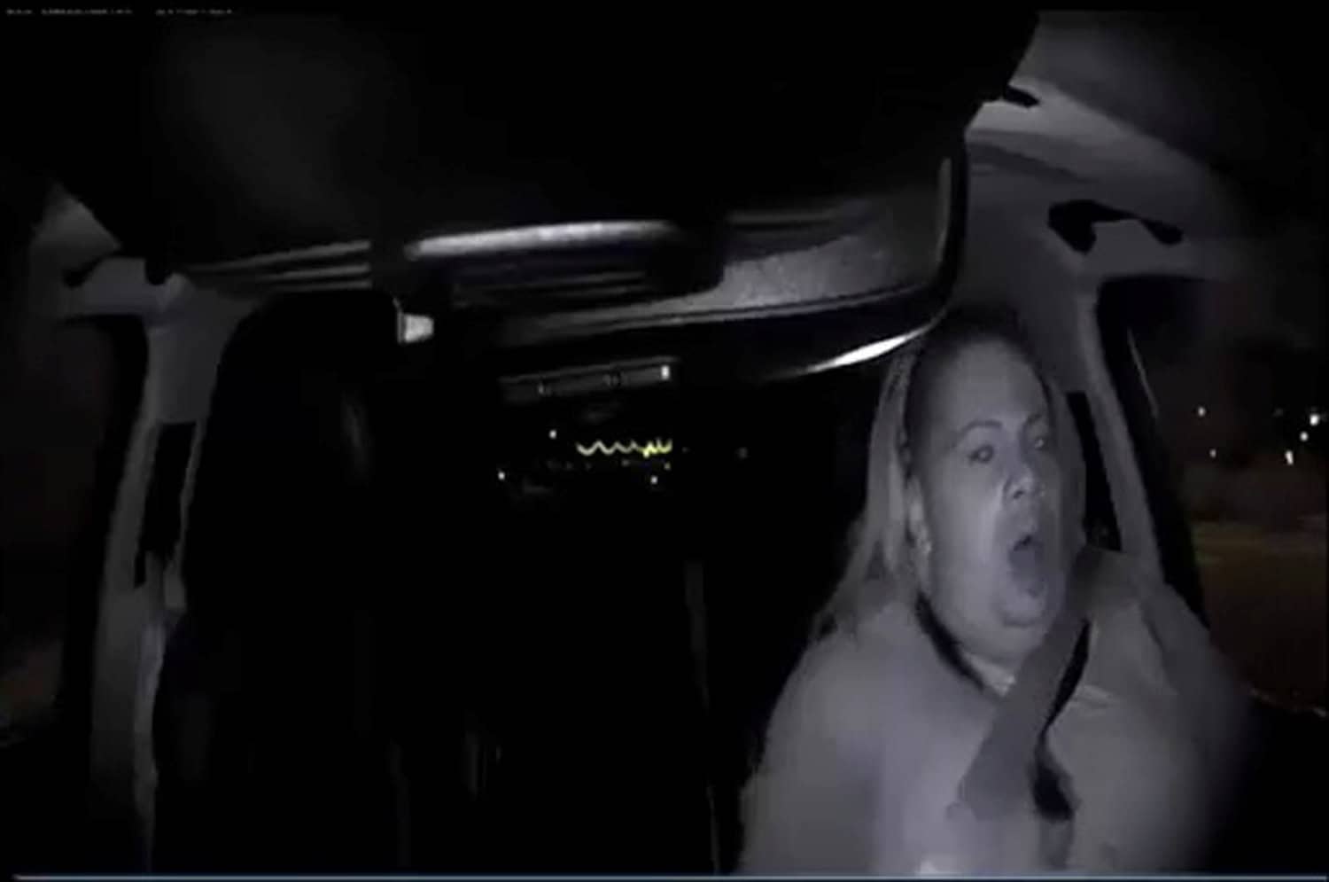 A handout photo of a still frame taken from video released March 21, 2018 showing the interior view of an unidentified operator in a self-driving Uber vehicle reacting as she looks through the windshield leading up to a fatal collision in Tempe