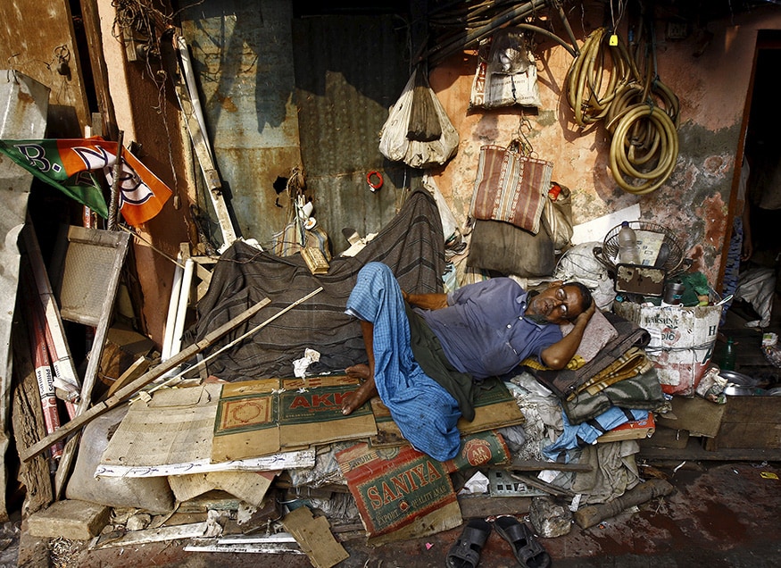 A labour takes a nap in a wholesale fruit market area in Kolkata. (Image: Reuters)