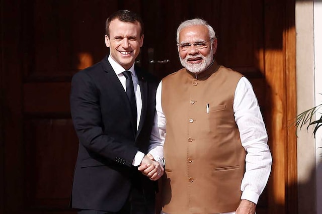 PM Modi (R) shakes hands with French President Macron as he arrives for an event in New Delhi (File phot: Reuters)
