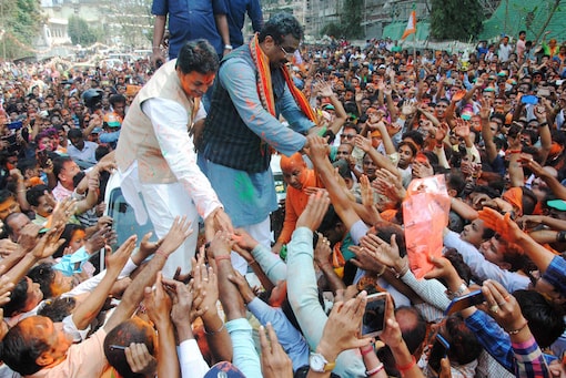 BJP National General Secretary Ram Madhav and Tripura BJP chief Biplab Kumar Deb greet supporters after party's victory in Tripura Assembly elections in Agartala on Saturday. (PTI Photo) 