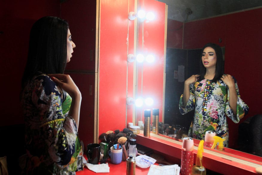 Marvia Malik, Pakistan’s transgender news anchor, checks herself in the mirror before a news broadcast at the Kohenoor News channel in Lahore