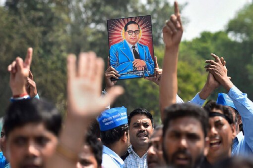 Members of Dalit community display a portrait of Bhim Rao Ambedkar during  a protest march (File photo)