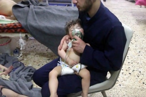 A medical worker is seen giving oxygen to a toddler through respirators following an alleged poison gas attack in the opposition-held town of Douma, in eastern Ghouta, near Damascus, Syria. (Image: AP)