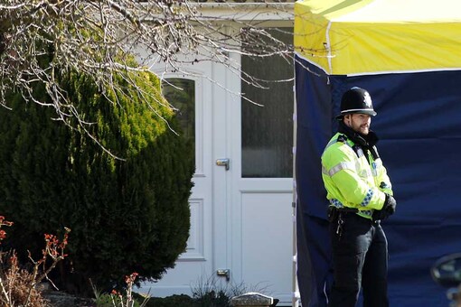 A police officer stands guard outside of the home of former Russian military intelligence officer Sergei Skripal, in Salisbury, Britain. (Reuters/Peter Nicholls)
