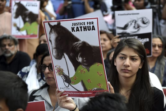 People display placards as they take part in a protest against the Kathua rape case in New Delhi. (PTI Photo) People display placards as they take part in a protest against the Kathua rape case in New Delhi. (PTI Photo)