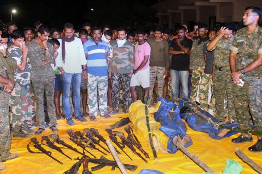 Security personnel show the guns recoverd from the Naxals killed in an encounter at Broriya forest area in Bhamragad taluka of Gadchiroli dustrict of Maharashtra on Sunday night. (PTI Photo)  
