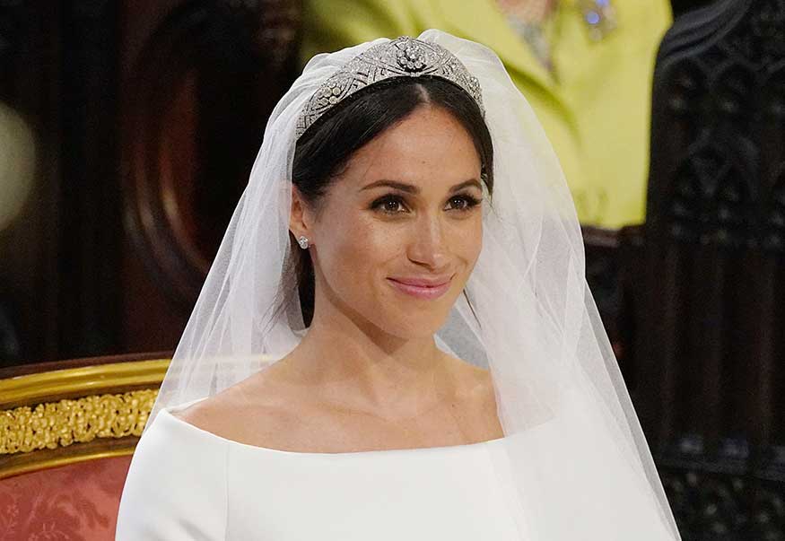 Markle complemented it with a tiara, an embroidered cathedral length veil, a bracelet and a small diamond stud earrings. (Image: AP)
