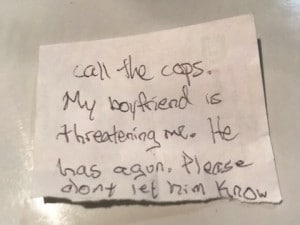 This undated photo provided by the Volusia County Sheriff's Office shows a note florida authorities say a woman slipped to a staff member at an animal hospital in Florida. Authorities say the woman was beaten and held captive for two days at gunpoint by her boyfriend, and escaped when she convinced him bring their dog to the animal hospital, where she slipped the note to a staff member. The Daytona Beach News-Journal reports 39-year-old Jeremy Floyd was arrested at DeLand Animal Hospital. (Volusia County Sheriff's Office via AP)