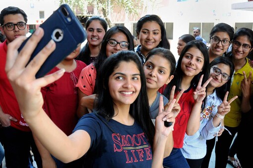 Students click selfies after the announcement of CBSE results. (Image: PTI)