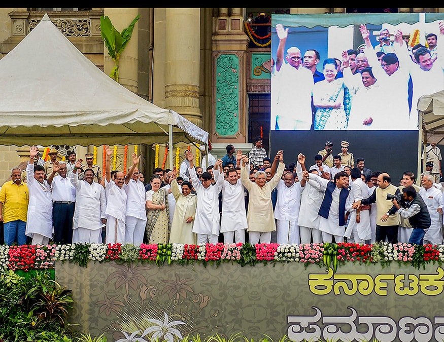 Leaders of different Indian political parties raise their hands during the swearing-in ceremony of Janata Dal (Secular) leader H. D. Kumaraswamy and Congress party leader G. Parameshwara as Chief Minister and Deputy Chief Minister of the state in Bangalore. (Image: AP)